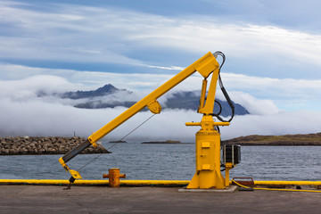Fishing crane in small seaside Iceland town harbor.