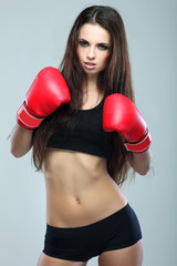 Beautiful sexual boxing girl, fitness, on a grey background