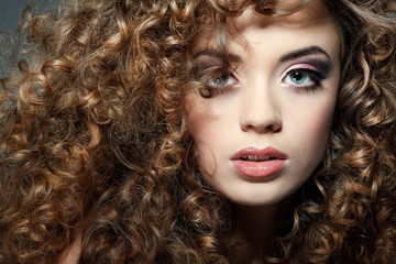 Young beautiful woman with long curly hairs