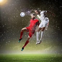 Foto auf Acrylglas Fußball zwei Fußballspieler, die den Ball schlagen
