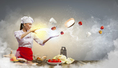 Asian female cooking with magic