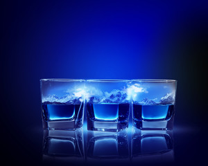 Three glasses of blue liquid