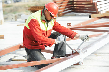 builder worker assembling metal construction