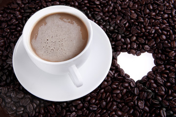 Coffee cup with beans and heart shape