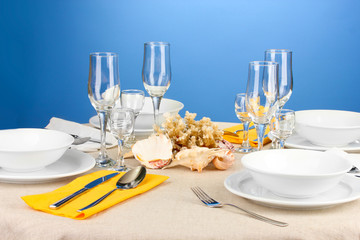Table setting in white and yellow tones on color  background