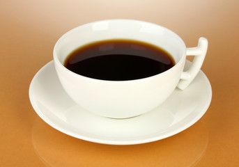 A cup of strong coffee on beige background