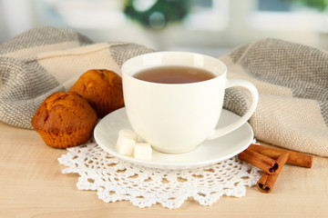 cup of tea with scarf on table in room