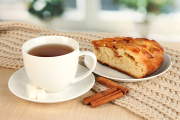 cup of tea with scarf on table in room
