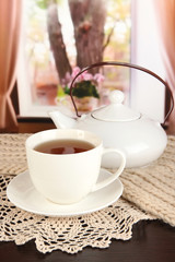 cup of tea with scarf on table in room