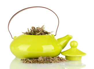 Dried herbs in teapot, isolated
