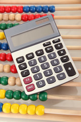 Bright wooden toy abacus and calculator, close up