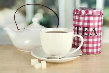 Jar and cup of tea isolated on white