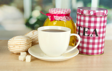 Jar and cup of tea isolated on white