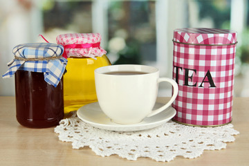 Jar and cup of tea isolated on white