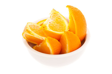 Bowl of orange slices isolated on white background