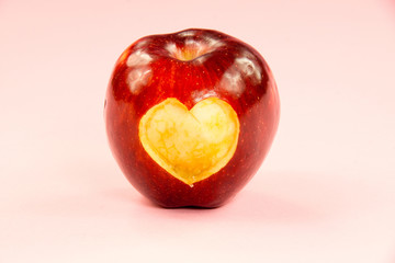 Valentine's day apple with heart on pink background