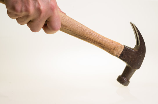 Carpenter Swinging A Hammer On White