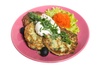 Roasted cutlets of potato with salmon on a plate