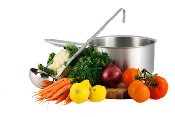 Soup pot, ladle and fresh vegetables isolated on white