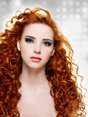 Fototapeta premium Beautiful woman with long curly hairs