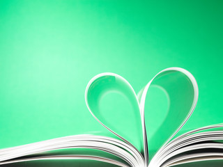 pages of a book curved into a heart shape