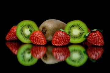 strawberries and kiwi on a black background with reflection