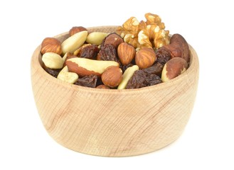 A wooden bowl of mixed fruit and nuts on white background