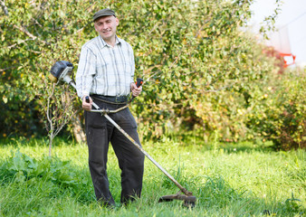 man mows the grass