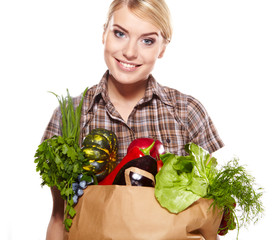 woman holding a shopping bag full of groceries, mango, salad,  r