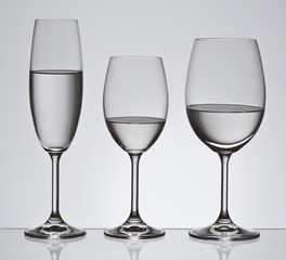 Bohemian crystal glasses filled with water; aligned backlit