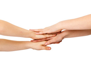 Two kids' hands lying on each other, isolated white