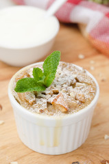 apple pie with walnuts and mint in a white ramekin closeup