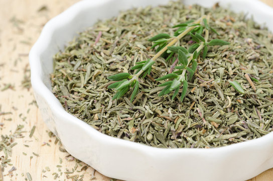 Dried and fresh thyme in a white bowl, selective focus, closeup
