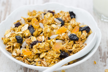 pumpkin granola with dried fruit and seeds in a bowl closeup