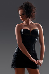 desired brunette woman posing in leather corset