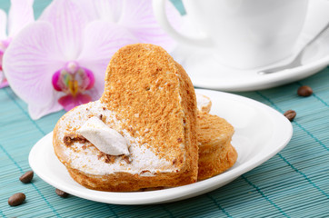 Heart shaped cake with coffee cup  aside