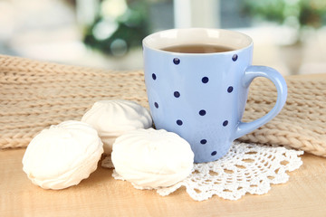 cup of tea with scarf on table in room