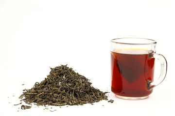 Leaves of tea and cup of tea on the white background
