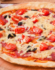 pizza with salami and tomatoes