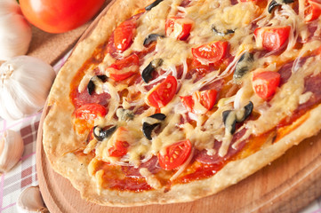 pizza with salami and tomatoes