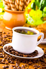 Coffee cup with fresh coffe beans for breakfast
