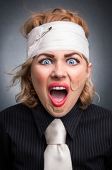 Agressive beaten woman screaming, head shot of funny female