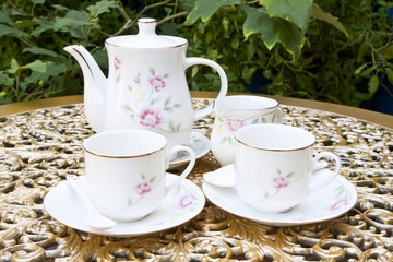 Tea for Two in the Garden on Golden Decoration Table