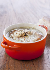 Onion soup in orange cocotte