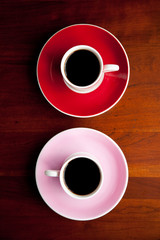 Red and pink coffee cup and saucer top view