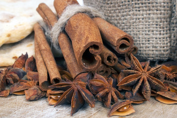 Cinnamon , anise and bread on wooden  table