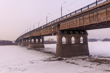Bridge across the frozen river in Omsk. Siberia.