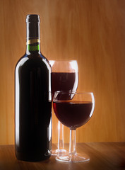 Red wine glass and Bottle on a wooden background