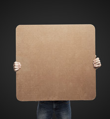 man holding blank poster