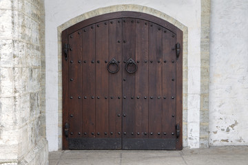 Dark wooden door with antique metal handles
